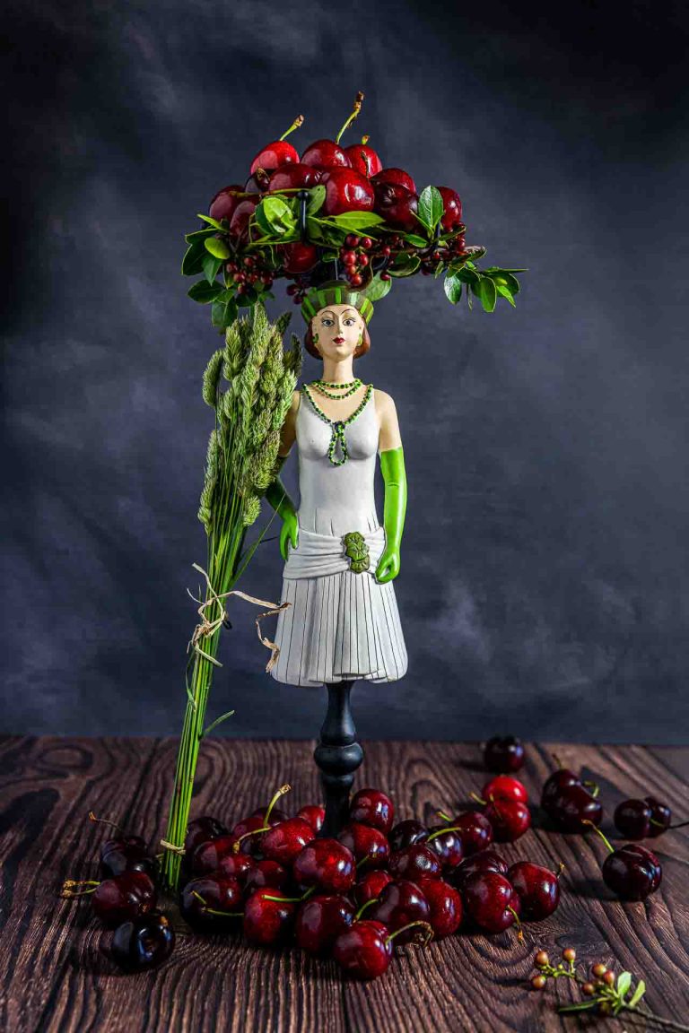 Photos fruits et légumes. Une couronne de cerises sur une statuette.